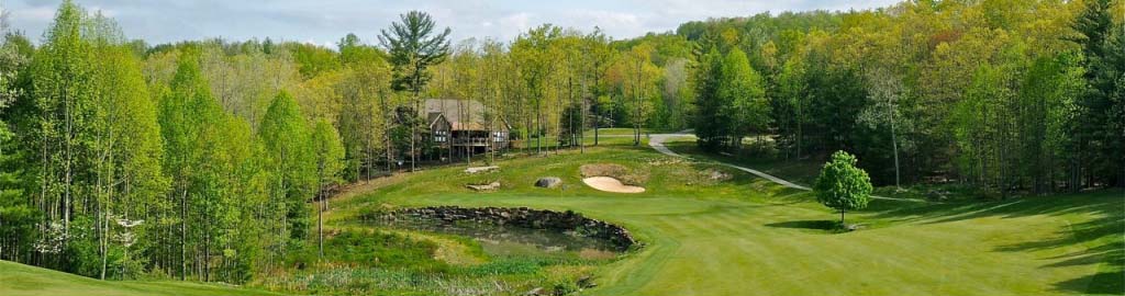 Sweeping clouds overlook the golf course with the clubhouse in the background.