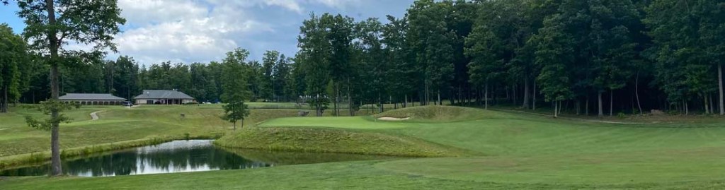 View of the clubhouse from the golf course with a bright blue sky.